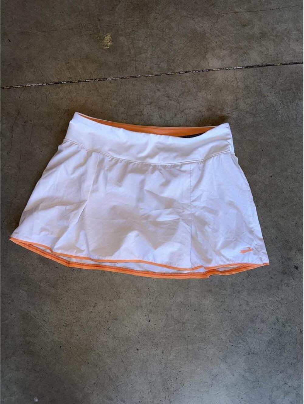white and orange Brooks Chaser Skort